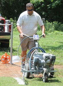 Georgia GCSA board member Tommy Hewitt from Windemere Golf Club in Cumming, Ga., lines the baseball field.