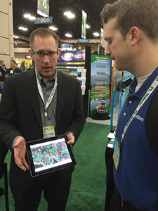 Winfield Branded Products Manager Aaron Johnson demonstrates the company's new GeoTech tool to Golfdom's Grant Gannon.