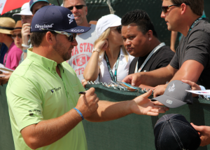 Graeme McDowell signs autographs for some fans.