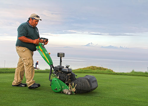 Walk-mowing a tee box. Check out that Wisconsin sky over Lake Michigan!