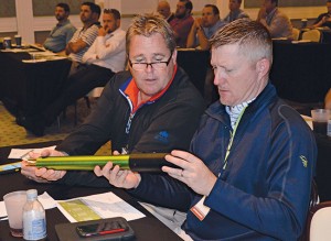 Woody Moriarty, superintendent at Blue Hills CC, Kansas City, Mo. (left), and Bill Irving, superintendent at Lawrence (Kan.) CC, get close with the Pogo soil monitoring tool. (Editor's note: Irving will be the new superintendent at Wolf Creek GC in Olathe, Kan., starting March 1.)