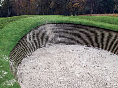 The use of stacked artificial sod on bunker walls is relatively new but can be found on golf courses in North America, Europe, Asia and Australia. This bunker is from a project at the Royal Antwerp Golf Club in Belgium.