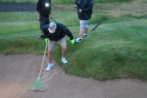 Prickette steps out of a bunker he raked on Erin Hills' 10th hole