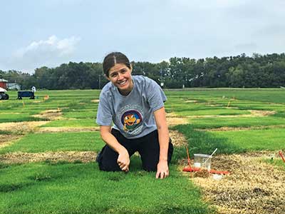 Woman burying oats in thatch