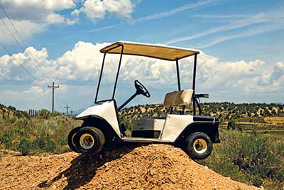 Golf cart stuck on dirt mound