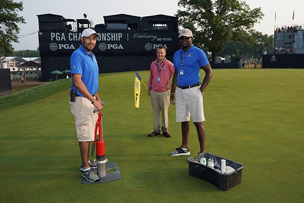 Grounds crew cutting the hole on the 18th green during the final round of the 100th PGA Championship. (Photo: Montana Pritchard/PGA of America)