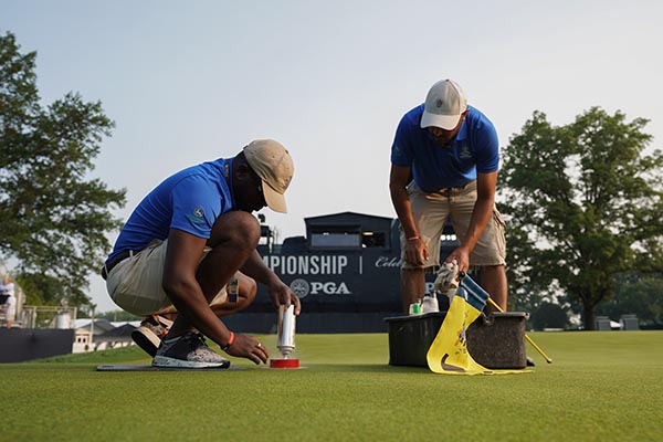 Grounds crew painting the cup on the 18th green during the final round of the 100th PGA Championship held at Bellerive Golf Club on August 12, 2018 in St. Louis, Missouri. (Photo: Montana Pritchard/PGA of America)