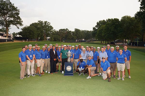 Brooks Koepka, winner of the 100th PGA Championship at Bellerive Country Club, poses with the grounds crew. (Photo by Montana Pritchard/PGA of America)