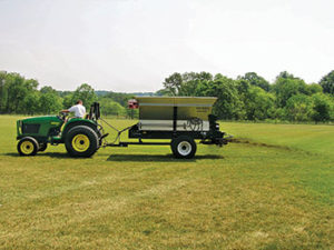 Topdressing units with large hoppers, belts and brushes mounted in the rear are preferred for surface applications. (Photo: Pete Landschoot)