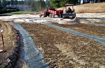 Placement of the sand cap above the soil. (Photo: Bert McCarty)