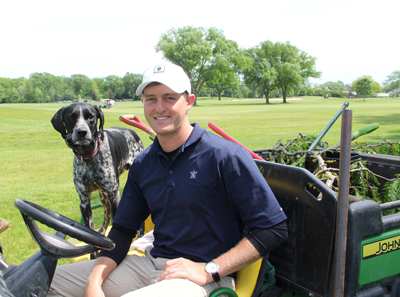 NAME with Knollwood Club dog NAME. Photo: Golfdom Staff