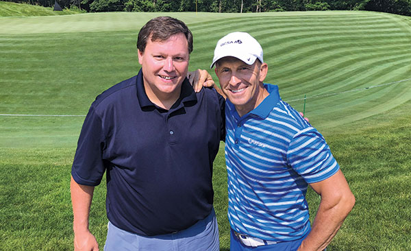 Manny Gan (left), director of global golf for John Deere, and Rhett Evans, CEO of GCSAA. (Photo: Seth Jones)