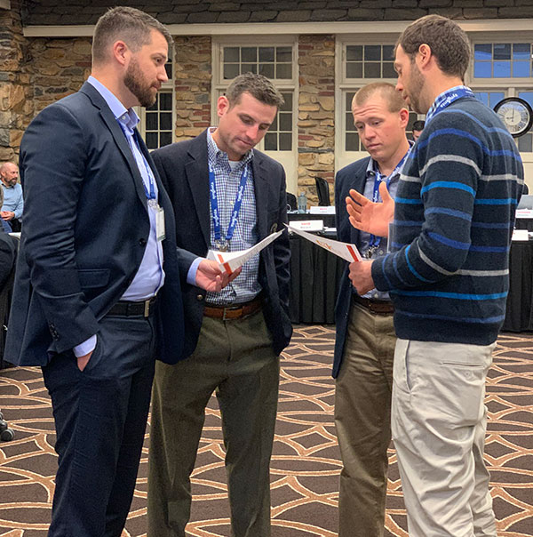 Jason Tharp, Scott Rettmann, Kevin Mark and Ian Schlather serve as representatives from several breakout groups who have to work together to negotiate an agreement during a breakout session at the Syngenta Business Institute. (Photo: Golfdom Staff)