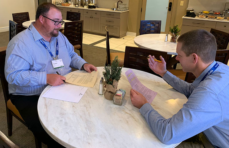 Thomas Slevin (left) and Dave Marach represent a buyer and a seller as they work to negotiate a mock deal at the Syngenta Business Institute. (Photo: Golfdom Staff)