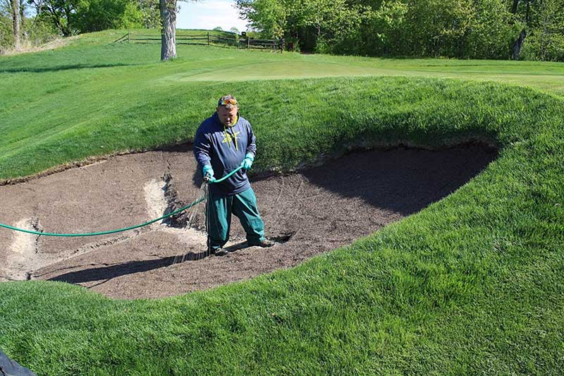 Klingstone, a liquid-applied polymer bunker barrier, is applied to a bunker at Spring Hill Golf Club in Wayzata, Minn. (Photo: Tim Johnson)