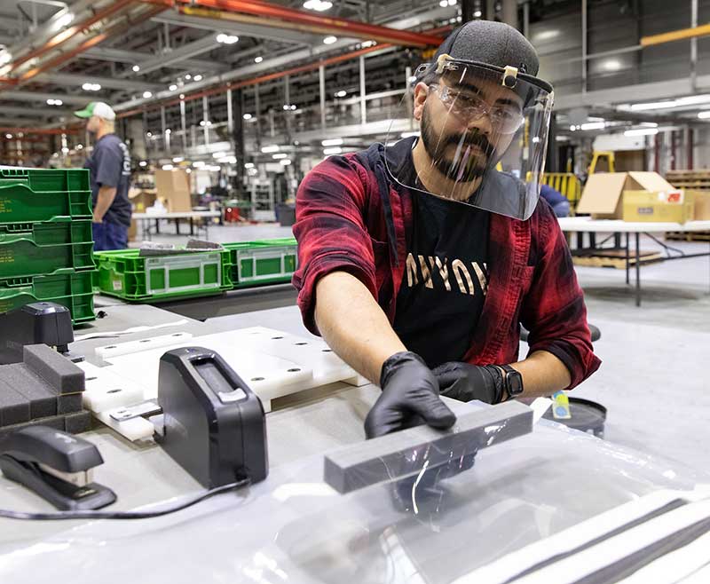 Jose Martinez, an assembler at John Deere Seeding Moline, assembles protective face shields for health care workers. (Photo: John Deere)