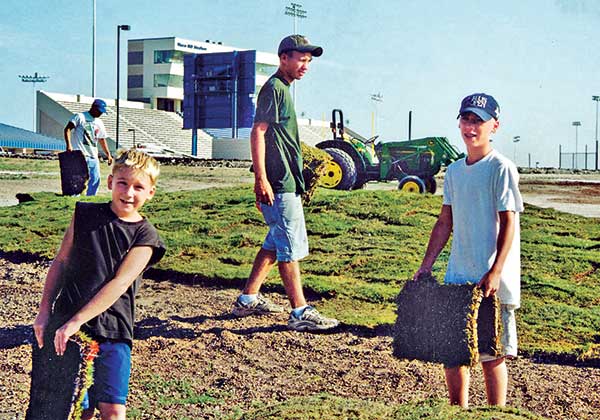 Nine-year-old Patrick Moore, 15-year-old Travis Moore and 13-year-old Andrew Moore help construct the junior course at Cottonwood Creek Golf Course in Waco, Texas. (Photo: The Moore family) 