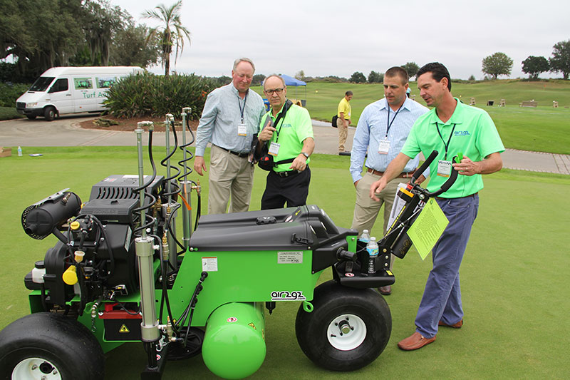 Glen Black, Air2G2 founder, (second from left) leads a demonstration of the Air2G2 at the Golfdom Summit. (Photo: Golfdom Staff)