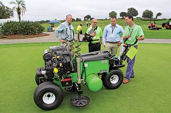 Superintendents get a demo of the Air2G2 from inventor Glen Black (second from left) at a past Golfdom Summit. (Photo: Golfdom Staff)