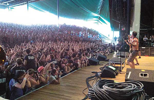 Zack Merrick performs as the bassist at an All Time Low concert at the Merriweather Post Pavilion in Columbia, Md. (Photo courtesy of Mark Merrick, CGCS)