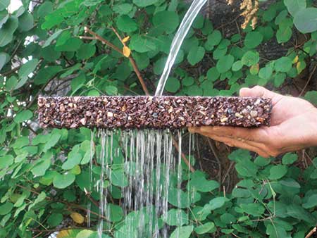 Porous Pave XL permeable paving material gets doused to show the product’s drainage capabilities. (Photo: Porous Pave)