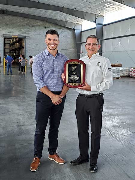 Vice President Grant Platz (left) and President Ted Platz commemorate Plant Food Co.’s 75th anniversary in 2021. (Photo courtesy of Plant Food Co.)