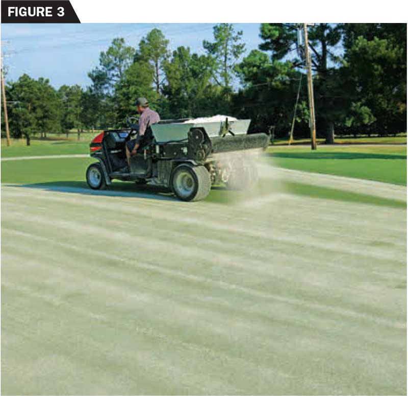 A drop-style topdresser can deliver sand to the putting surface with high precision. This operator is applying 1 cubic foot of sand per 1,000 square feet. (photo by: Brian Whitlark, USGA Green Section)