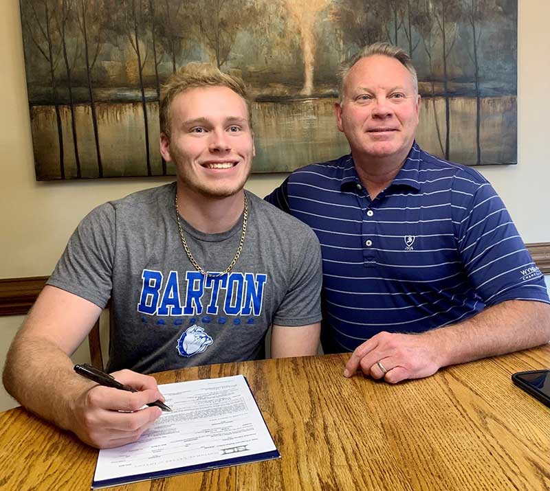 Carolinas GCSA scholar Parker Shoun with his father, Michael, on the day he signed to play lacrosse at Barton College. (Photo courtesy of Carolinas GCSA)