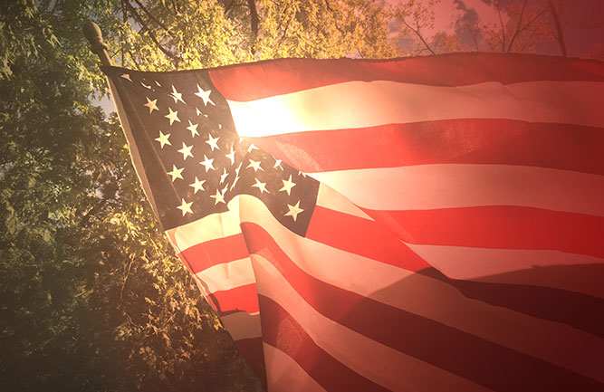 American flag with sunlight in background (Photo: iStock/Getty Images/Getty Images Plus/IrisImages)