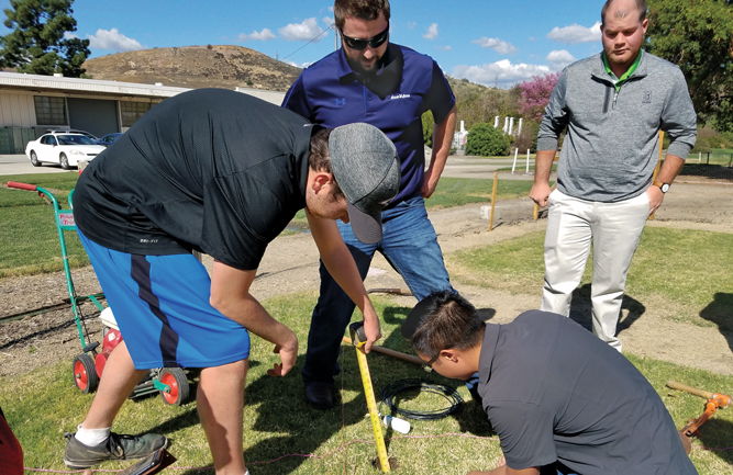 Students install a Rain Bird Integrated soil moister sensor in the bermudagrass fairway plot. (Photo courtesy of Priti Saxena, Ph.D.)