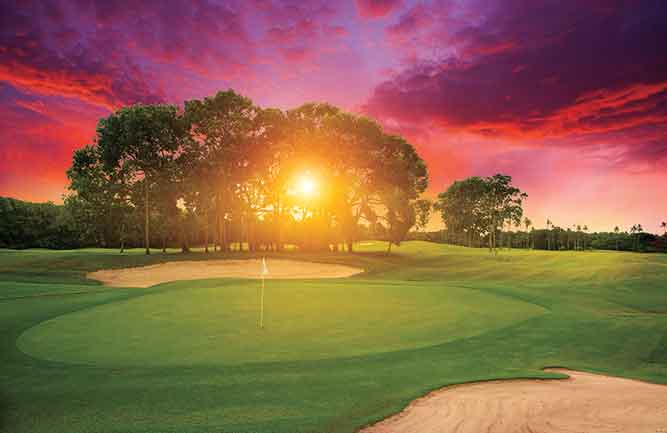 Golf course with sun in background (Photo by: KrivosheevV / iStock–Getty Images Plus / Getty Images)