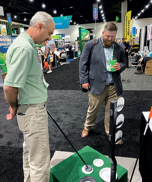 Rob Roberts, inventor of Spray Caddie Golf Cup Cover, gives a demo to Curtis Schriever, superintendent, Terradyne CC, Andover, Kan. (Photo courtesy of Spray Caddie)