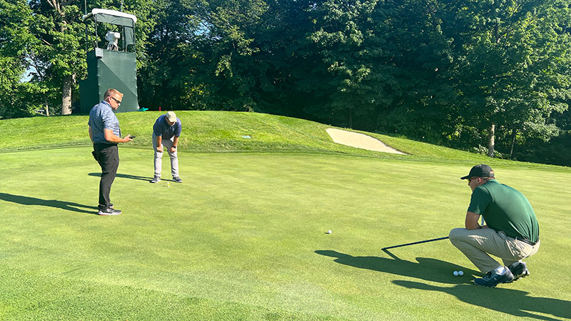 Alex Stuedemann, CGSC, and Jonathan Graham check out the green speeds on the No. 11 hole at TPC Deere Run ahead of the start of the John Deere Classic. (Photo: Golfdom Staff)