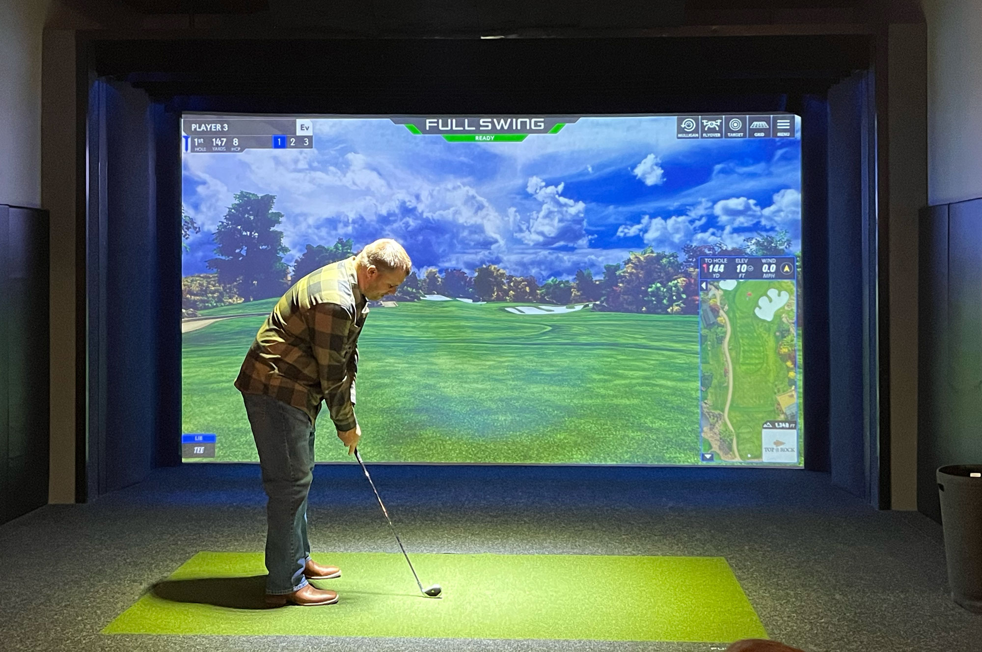 Nick Kray, superintendent at Elmcrest Country Club in Cedar Rapids, Iowa, takes a swing at the golf simulator. (Photo: Golfdom staff)