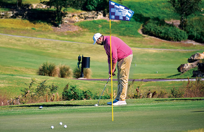 Graham Edelman, superintendent, Wolf Creek Golf Links in Olathe, Kan., lines up his putt. (Photo: Golfdom Staff)