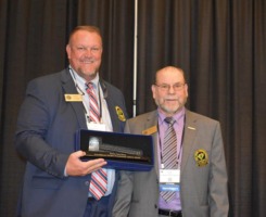 New Carolinas GCSA President, Alex Tolbert, presents a gavel to outgoing president, Pete Gerdon, recognizing his service to the 1,850-member organization. (Photo: Carolinas GCSA)