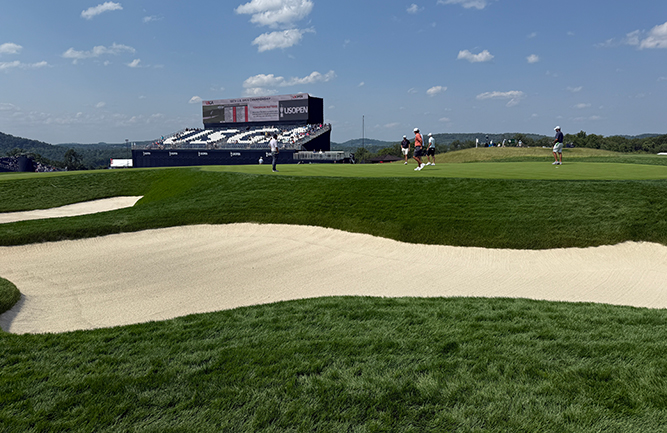 Deep bunkers beside the 17th green with the USGA grandstands looking on. (Photo: Golfdom staff)
