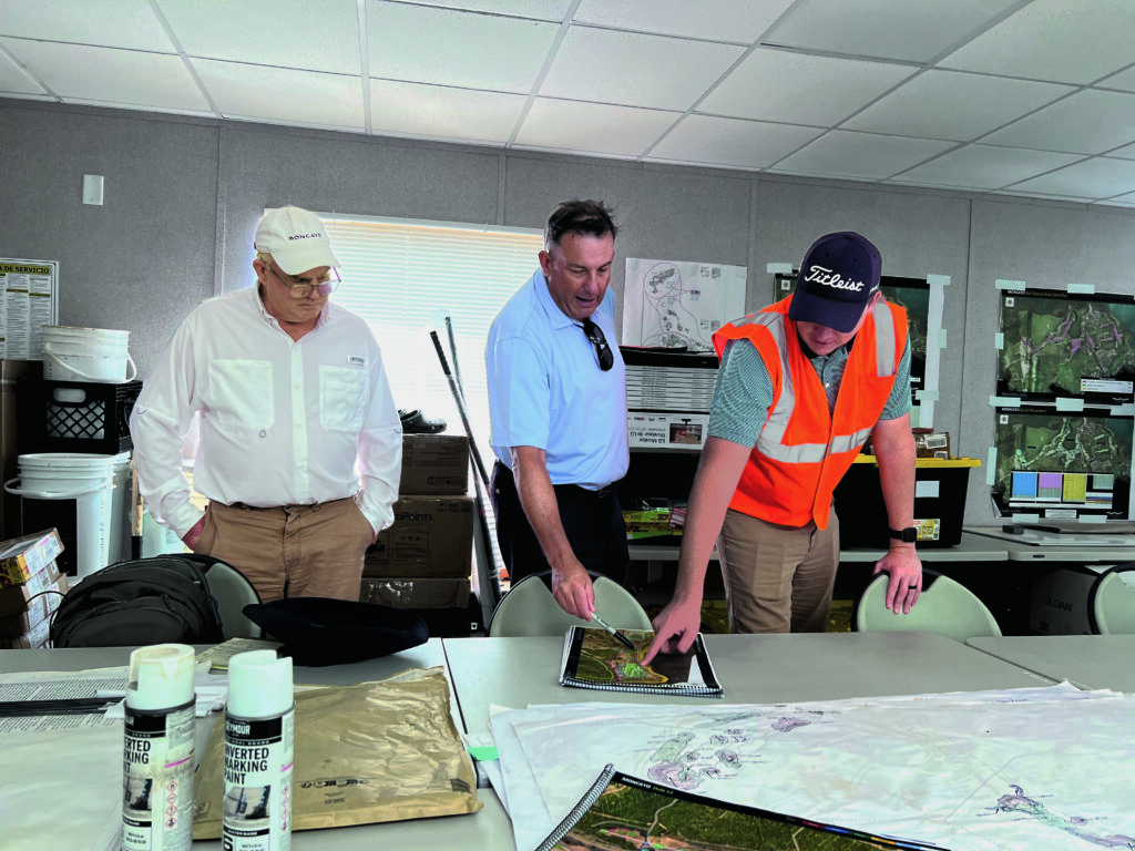 Chris May (left), Martin Ebert (center) and John Daniels look at the current state of a green under construction at Moncayo GC. “It’s not just for the greens. We’re defining the proposed levels for the whole golf course,” Ebert says. (Photo by: Golfdom staff)