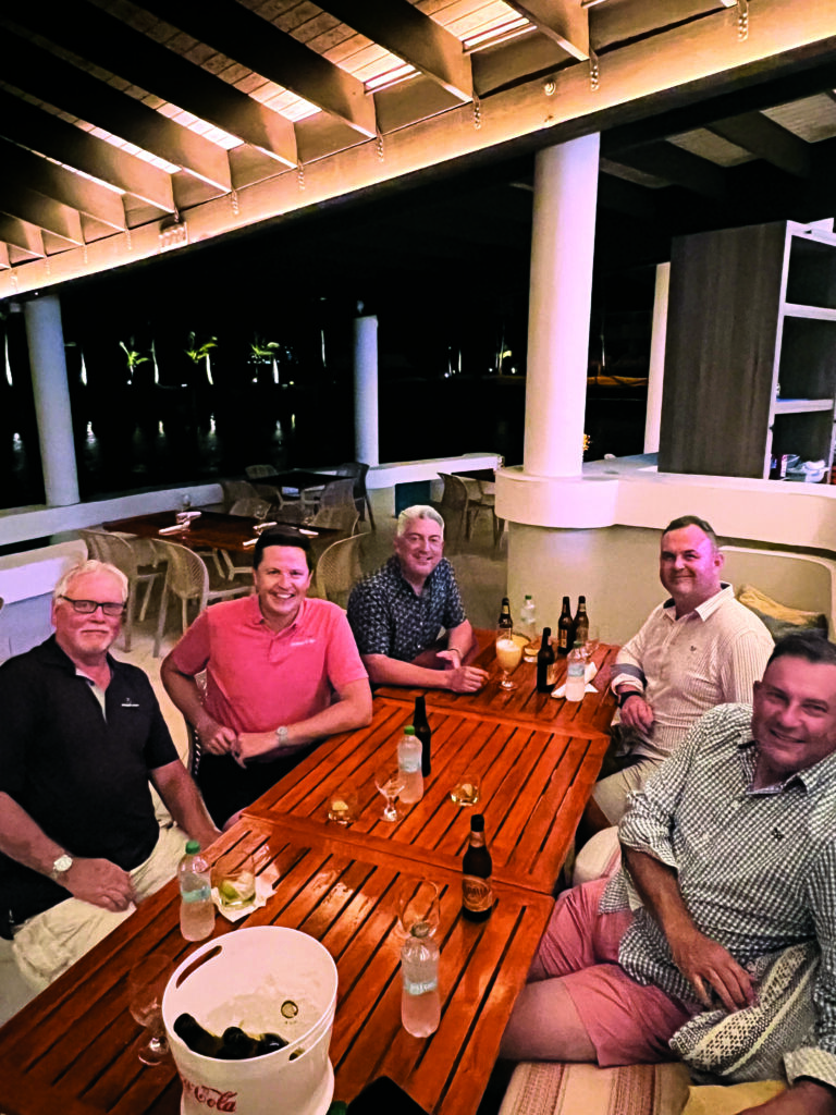 Medalla Lights all around!: While on assignment in Puerto Rico, the Moncayo crew took Jones out for dinner — and a few Medalla Lights, the official beer of Puerto Rico — on the coast. From left to right are Peter Bohn and John Daniels, both with Heritage Links; Jones; and Chris Huggett and Martin Ebert of Mackenzie and Ebert. (Photo: Golfdom staff)