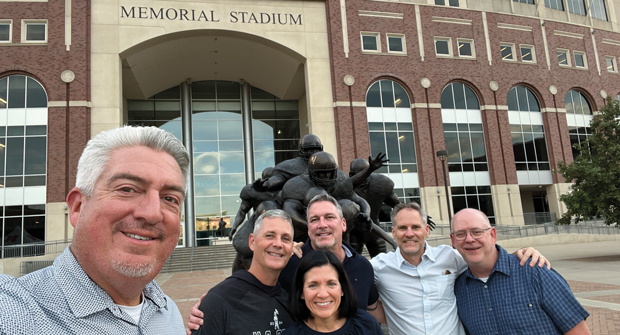 Go Big Red!: The Golfdom gang — Seth, Craig, Bill Roddy and Scott Hollister — made a trek to Lincoln, Neb., where they caught up with Jason Schmaderer (blue shirt) of Swanson Russell and Stephanie Hays of the Propane Education and Resource Council. (Photo: Golfdom staff)