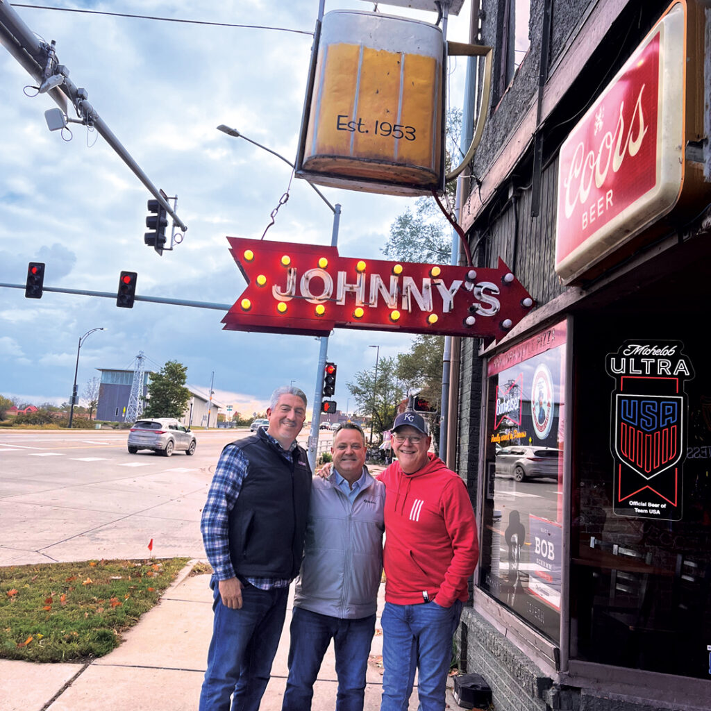Welcome to the team, Jim!: Longtime industry professional Jim Cummins — he worked for GCSAA for almost 20 years as their senior manager of business development — recently joined the Golfdom team as our national sales manager. To mark the occasion, Editor-in-Chief Seth Jones (left) and Editor Scott Hollister (right) took Cummins to Lawrence’s oldest tavern, Johnny’s, to celebrate. (Photo: Golfdom staff)