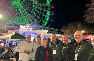 Jones with the team from PBI-Gordon, and outgoing GCSAA president T.A. Barker. Only now does Jones realize why he kept seeing the PBI-Gordon folks in that area. Still, the Ferris wheel at ICON Park looks cool. (Photo: Golfdom staff)