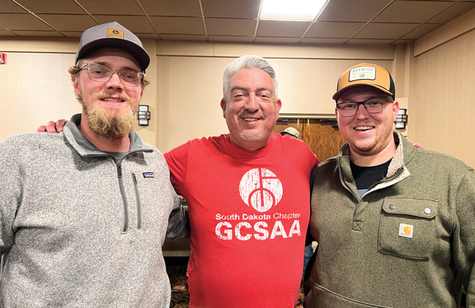 Red Friday: Jones couldn’t wait to break out the sweet SDGCSA swag he was gifted! Here he’s pictured with his new friends Ben Hoffman, assistant superintendent at Brandon (S.D.) GC and Jared Corlett, superintendent at Prairie Green GC, Sioux Falls, S.D. (Photo: Golfdom staff)