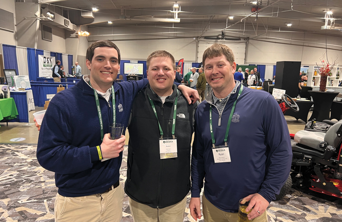 Putting in the (Turf)werk: Tony Hayes (left) and Ryan Lehmann (right), both of Minnehaha CC, Sioux Falls, S.D., grabbed Wade Stein of Turfwerks for this party pic on the trade show floor. (Photo: Golfdom staff)