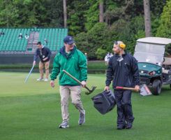 Two members of the maintenance crew at Augusta National Golf Club share a laugh during work. “Dr. Duich said it, ‘It’s 10 percent turfgrass and 90 percent people,’” Owen says. (Photo: Scott Ramsay)