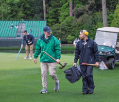 Two members of the maintenance crew at Augusta National Golf Club share a laugh during work. “Dr. Duich said it, ‘It’s 10 percent turfgrass and 90 percent people,’” Owen says. (Photo: Scott Ramsay)