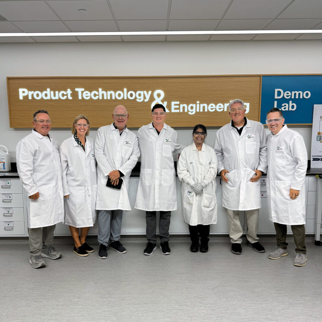 Back in the lab again: A recent trip to Syngenta got the Golfdom crew in lab coats and safety glasses to watch a presentation on the work that goes into creating a formulation. From left to right are Jim Cummins, Golfdom; Lyndsey Newnam, G&S Communications; Scott Hollister, Golfdom; Jake Goodman, Golfdom; Seefat Farzin, Ph.D., formulation chemist, Sygnenta; Jones; and Mark LaFleur, Syngenta. (Photo: Golfdom staff)