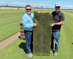 Roberto Gurgel and Joel Lane with a slab of HighPoint Bermudagrass. (Photo: Sod Solutions)