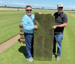 Roberto Gurgel and Joel Lane with a slab of HighPoint Bermudagrass. (Photo: Sod Solutions)
