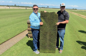 Roberto Gurgel and Joel Lane with a slab of HighPoint Bermudagrass. (Photo: Sod Solutions)